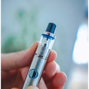 Ispire-Ducore-X-oil-cartridge-on-battery-lifestyle-photo