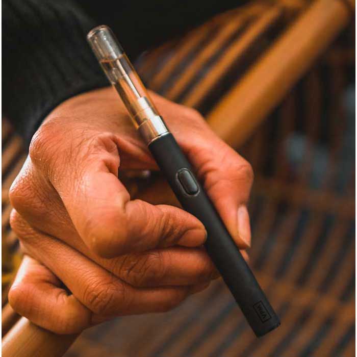 VPM B20 button cartridge battery lifestyle photo in hand